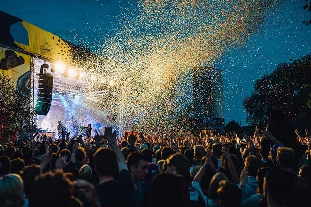 outdoor music concert with large stage and confetti in the air